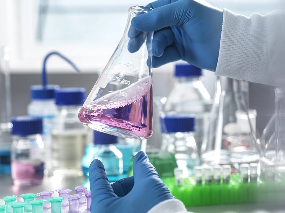 Close up of a scientist holding a flask
